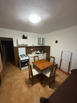Small kitchen with a dining table and chairs. - image 5