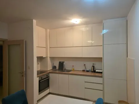 Small white kitchen with built-in home appliances. - image 3