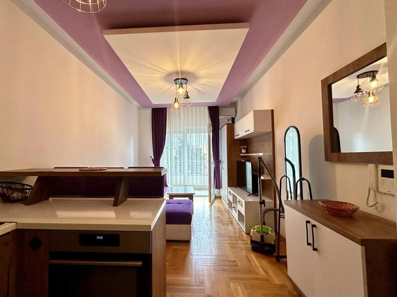 Living room with sofa and dining area.