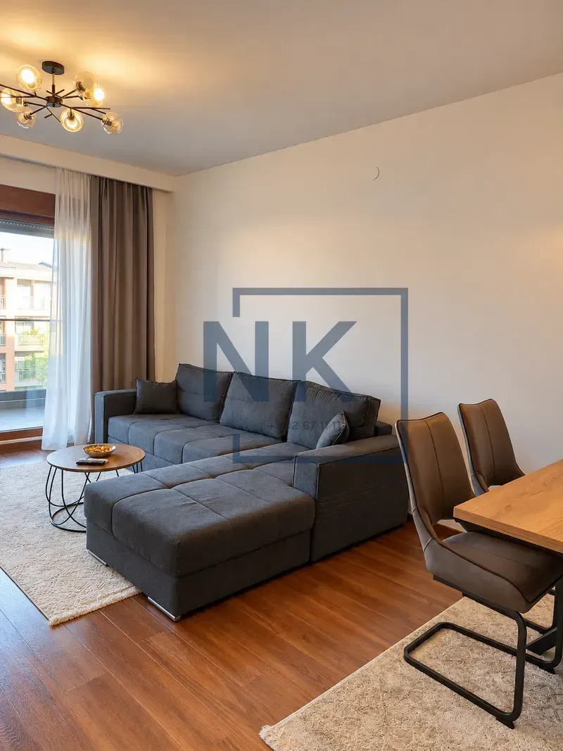 Living room with a sectional sofa, coffee table, and dining area.