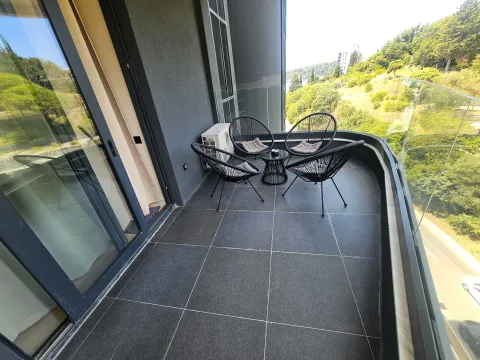 Modern balcony with seating set and surrounding view. - image 6