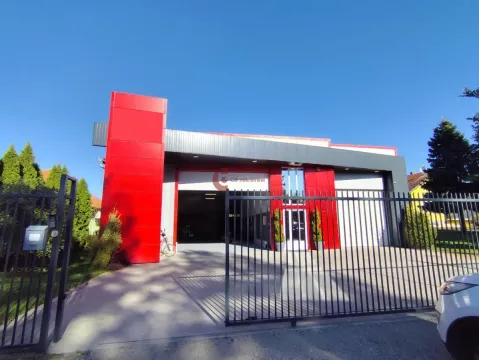 View of the exterior of the commercial building with a metal gate and courtyard. - image 2