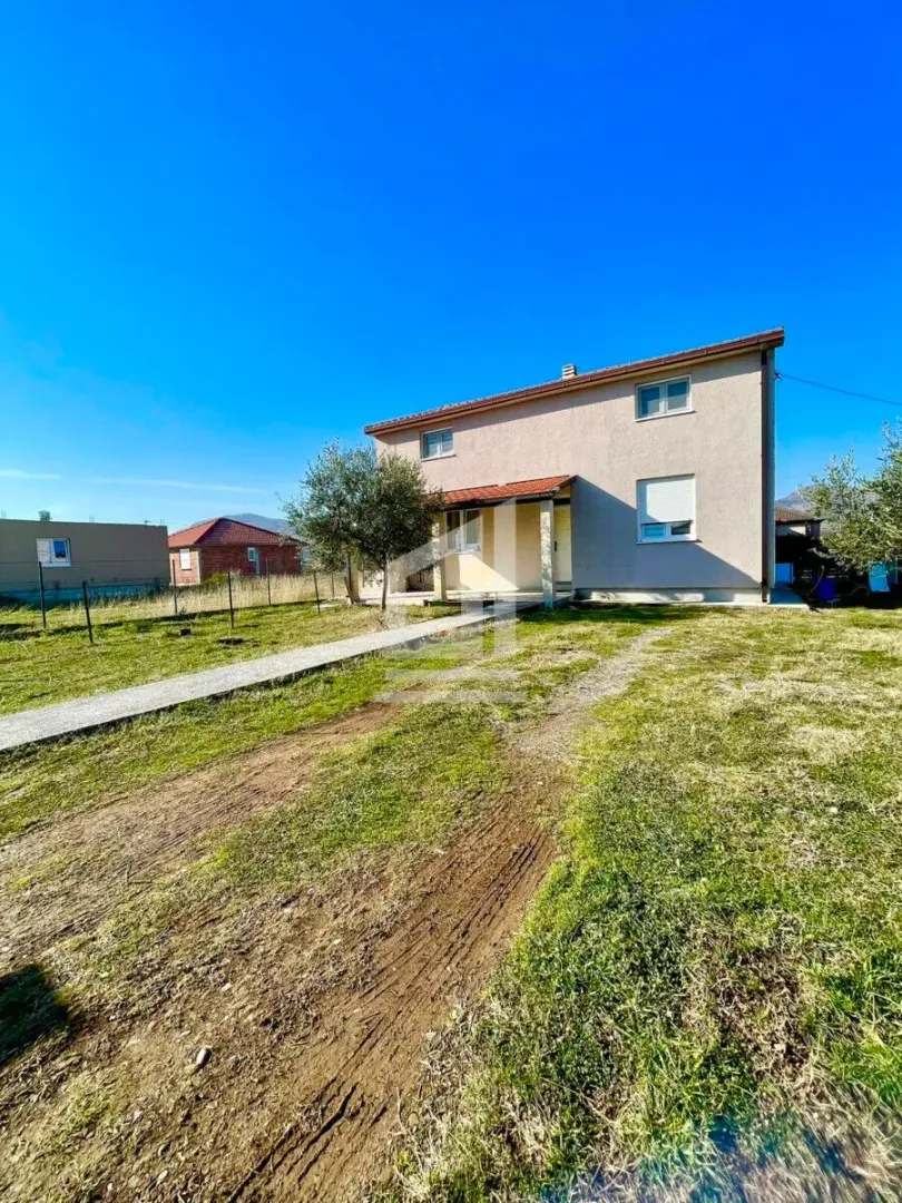 View of the yard and front facade of the two-story house.