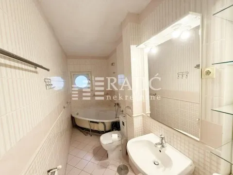 Bathroom with bathtub, sink, and toilet. - image 4