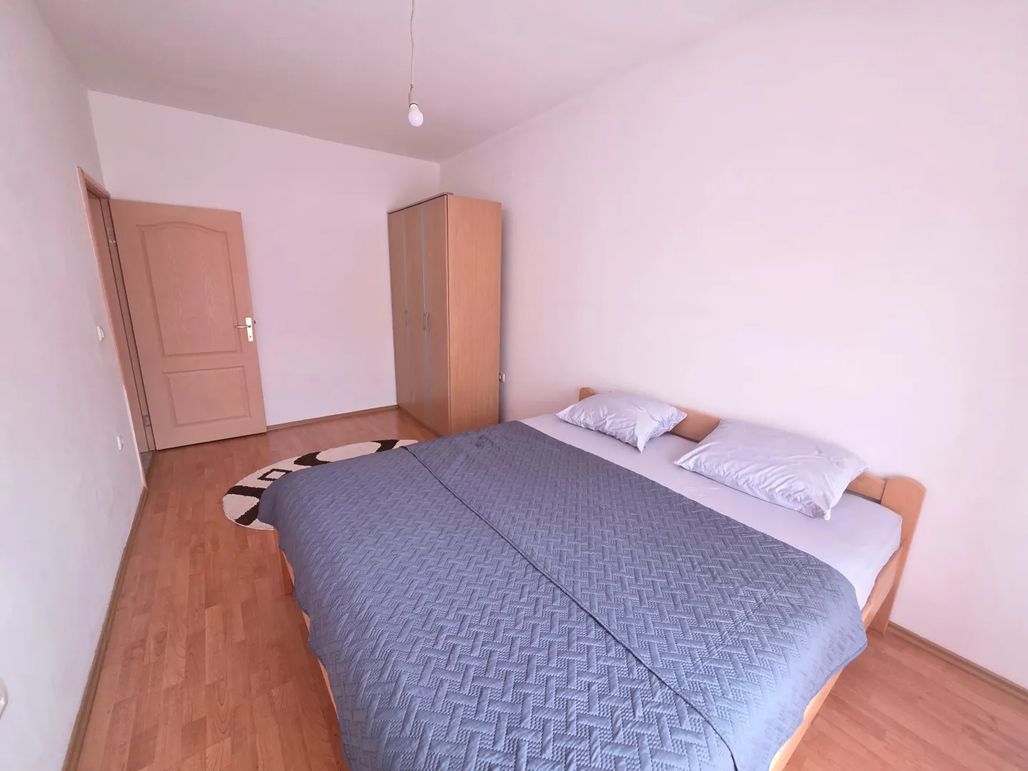 Bedroom with a double bed and a wardrobe.
