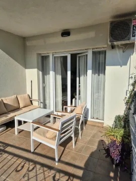 Furnished terrace with seating set and access to the apartment. - image 2