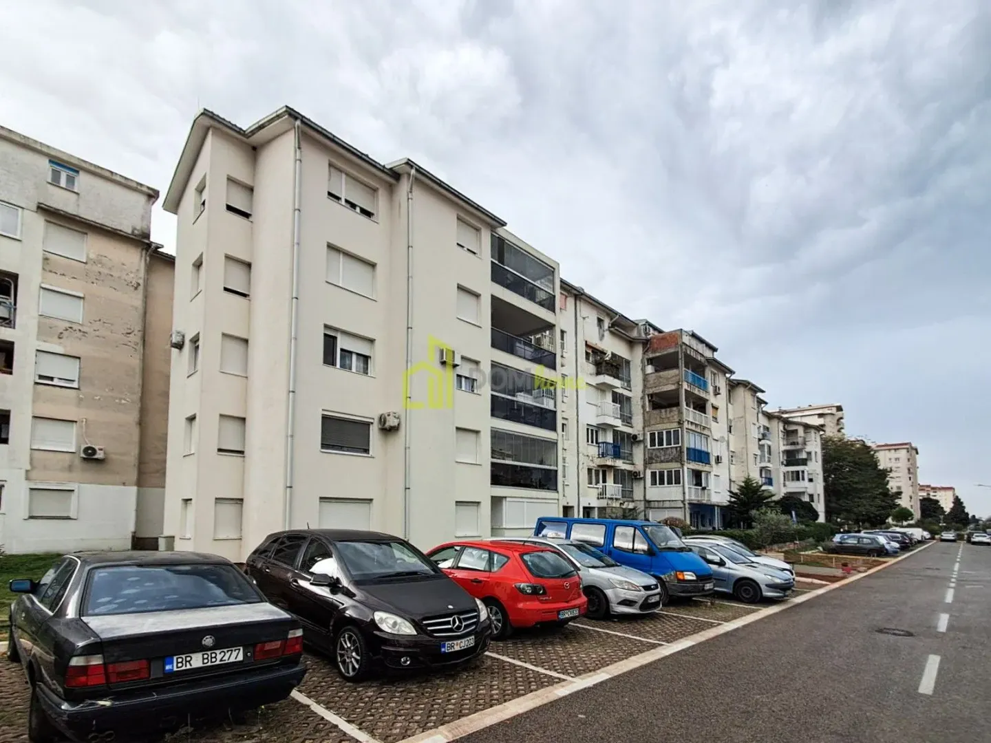 View of the exterior of the residential building with a parking lot.