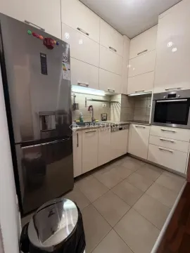 Modern kitchen with white cabinets and a stainless steel refrigerator. - image 5