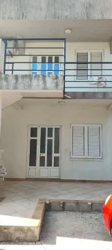 Exterior view of the house with a terrace, entrance door, and windows. - image 15