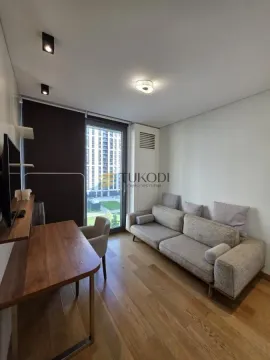Small living room with a sofa, desk, and access to the terrace. - image 16