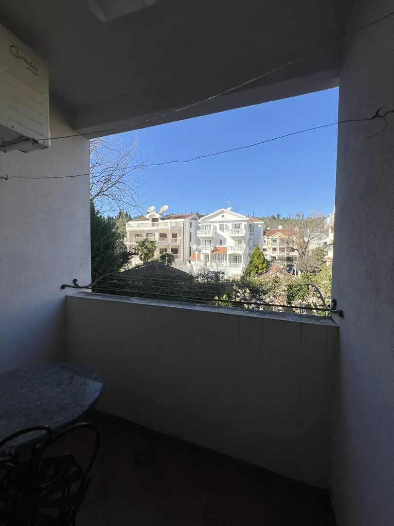 View from the terrace overlooking nearby buildings under a clear sky.