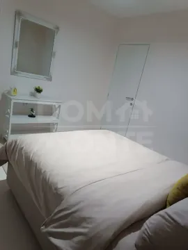 Furnished bedroom with a double bed, dresser, and mirror. - image 9