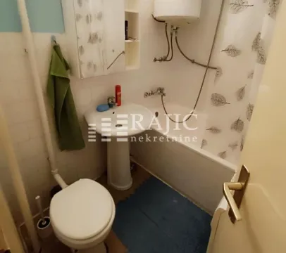 Small bathroom with a bathtub, sink, and toilet. - image 11