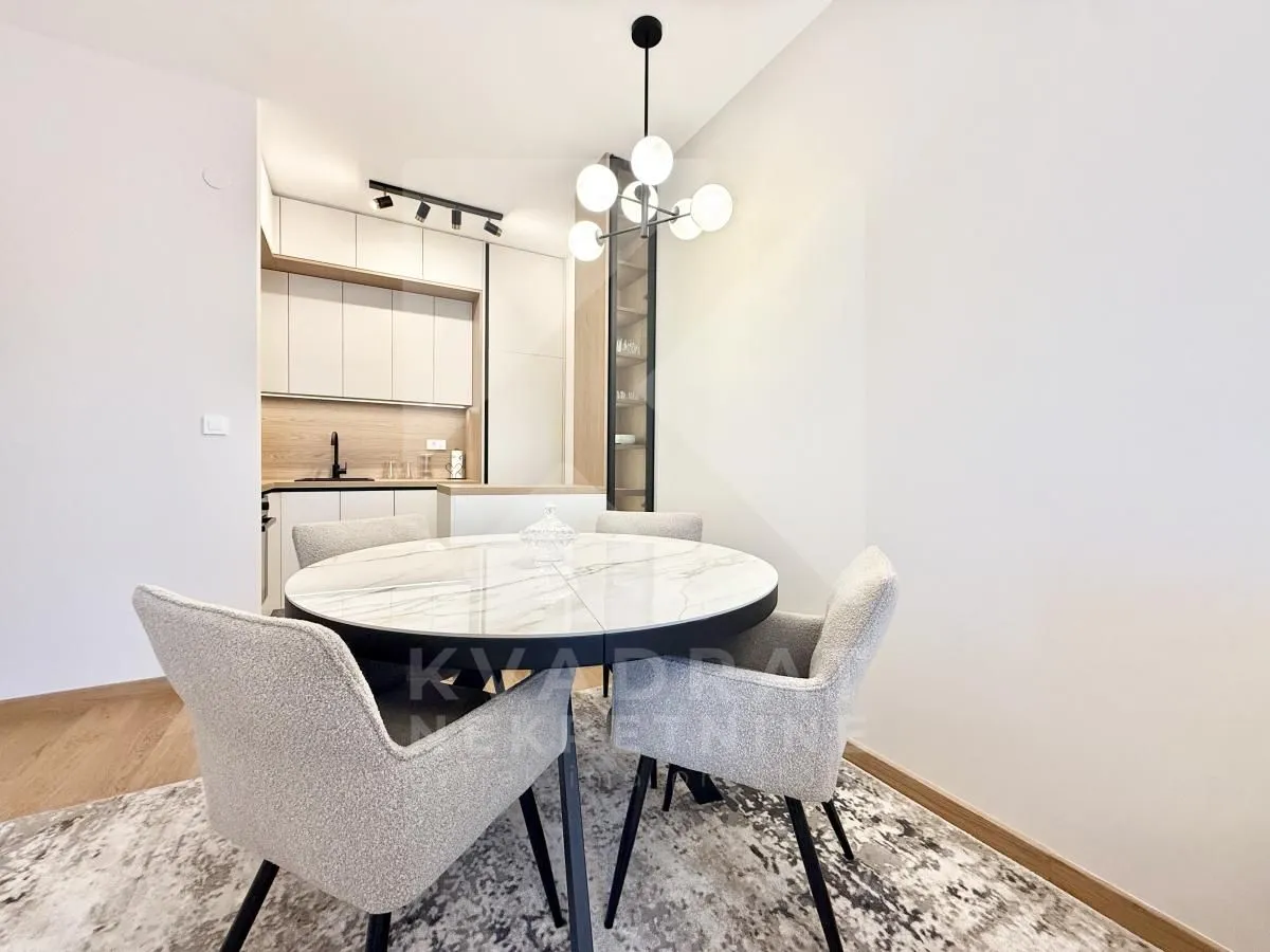 Dining area with a round table and chairs overlooking the kitchen.