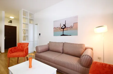 Living room with a sofa, armchairs, and a white coffee table. - image 4