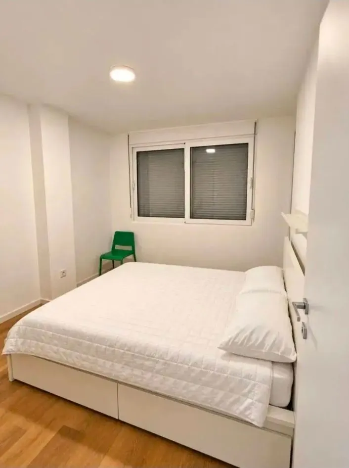 Bright and tidy bedroom with a double bed.