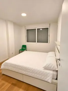 Bright and tidy bedroom with a double bed. - image 5