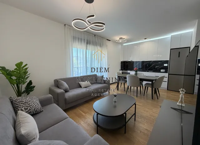 Modern and bright living room connected to the dining area and kitchen.
