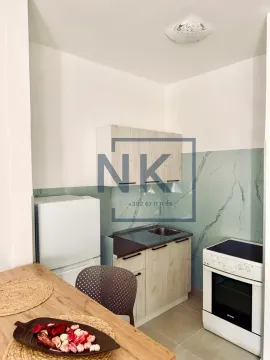 Small equipped kitchen with white goods and a dining table. - image 4