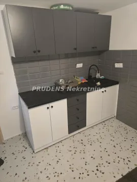 Smaller kitchen with lower and upper cabinets and a sink. - image 6