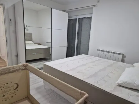 Bedroom with a double bed, a large wardrobe, and a baby cot. - image 3