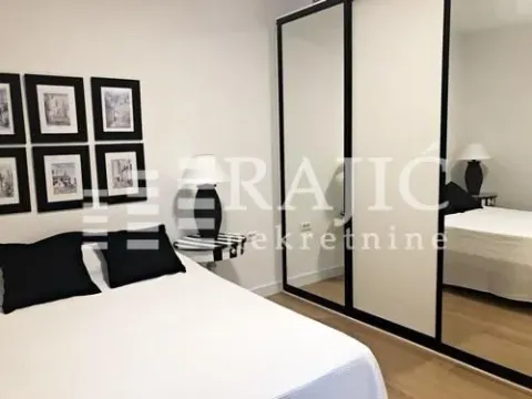 Decorated bedroom with a double bed, large mirrored wardrobe, and wall art details. - image 11
