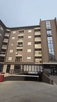 Exterior view of a modern residential building with a garage entrance. - image 4
