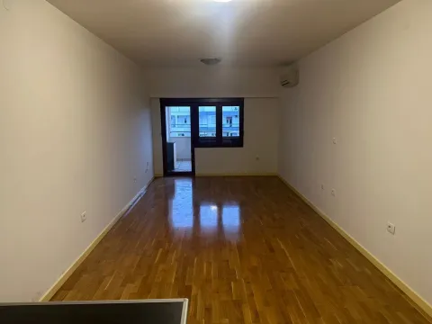 Empty room with parquet flooring and balcony access. - image 11