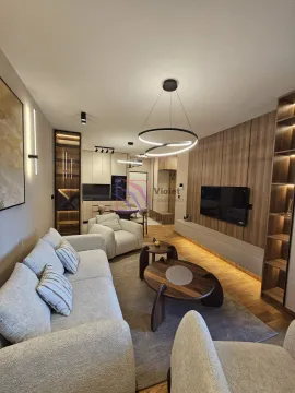 Modern living room with a sofa, TV, and dining area in the background. - image 8