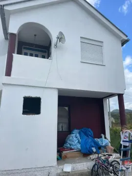 View of the exterior of the house with a balcony and yard. - image 12