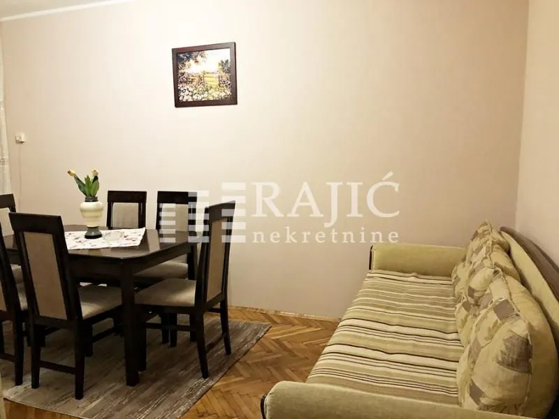 Living room with a sofa set and a dining table.