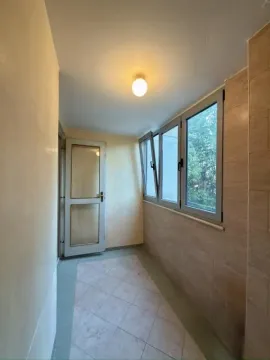 Enclosed balcony with floor tiles and windows. - image 2