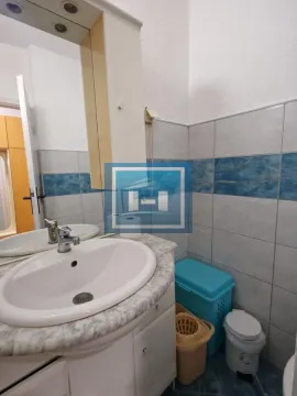 Smaller bathroom with a washbasin, mirror cabinet, and blue-toned tiles. - image 15