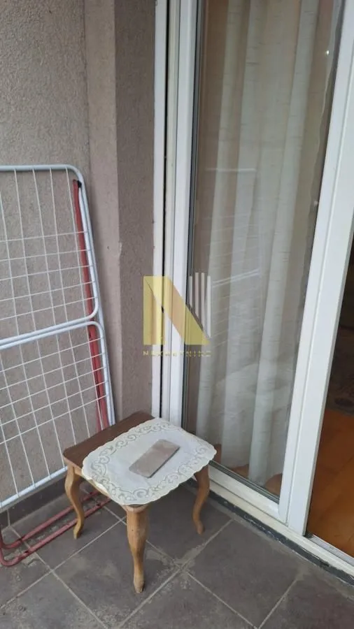 Manji balkon sa sušačem za veš i stolom.