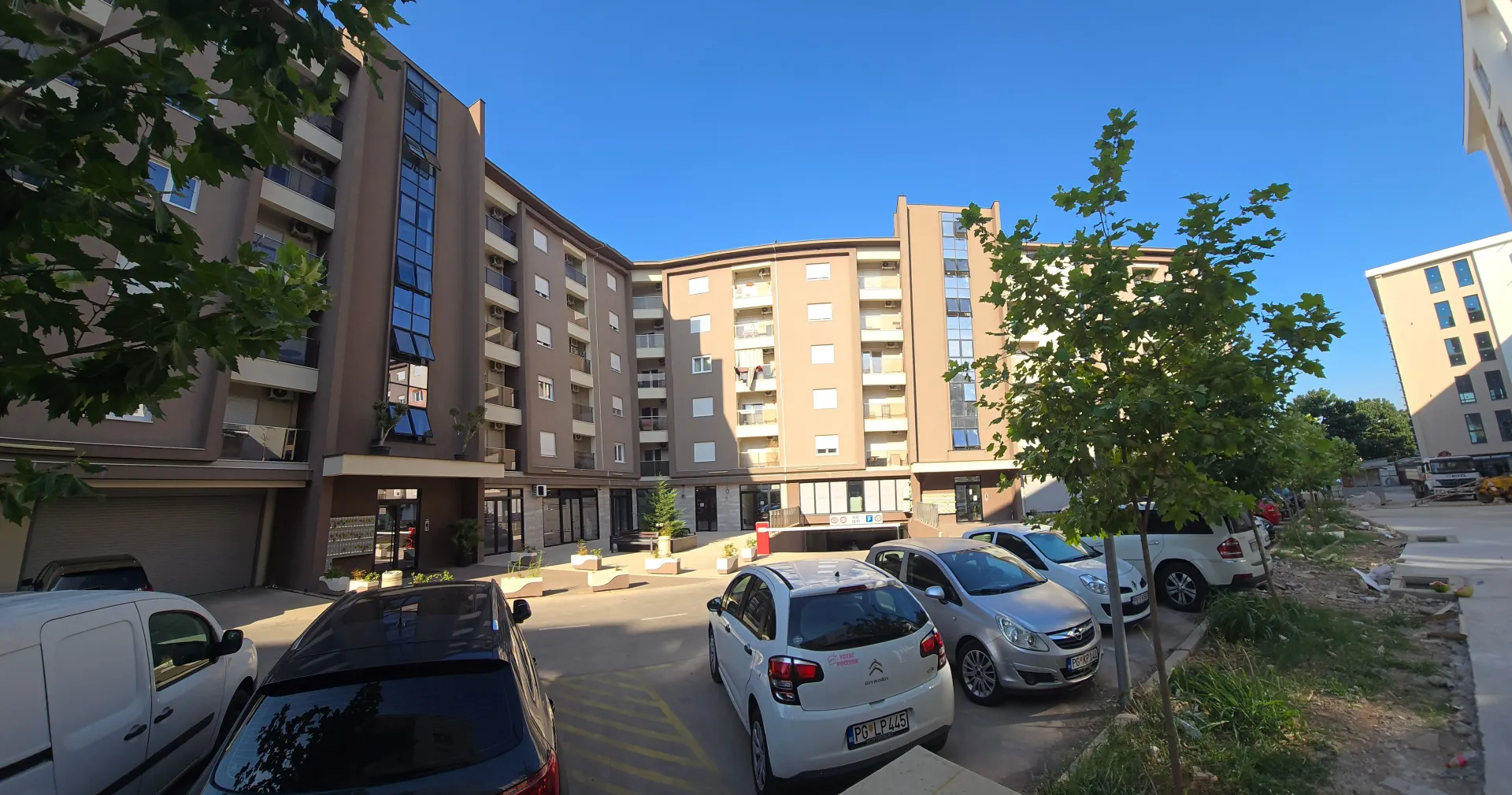 View of the exterior of the residential building and the courtyard with parking.