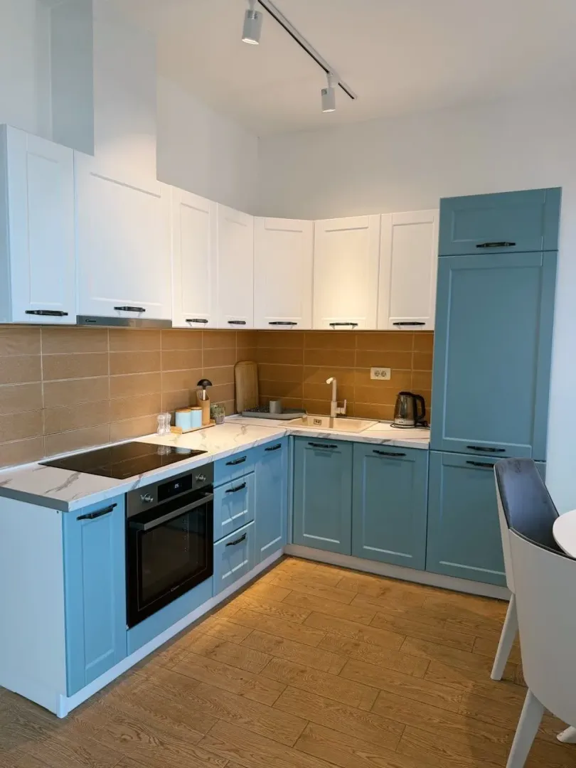 Modern kitchen with white and blue cabinets.