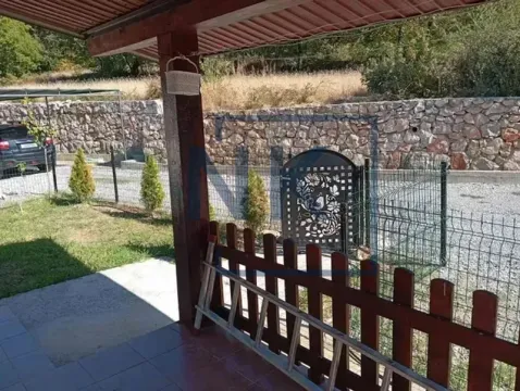 Covered porch in front of the house overlooking the yard and gate. - image 8