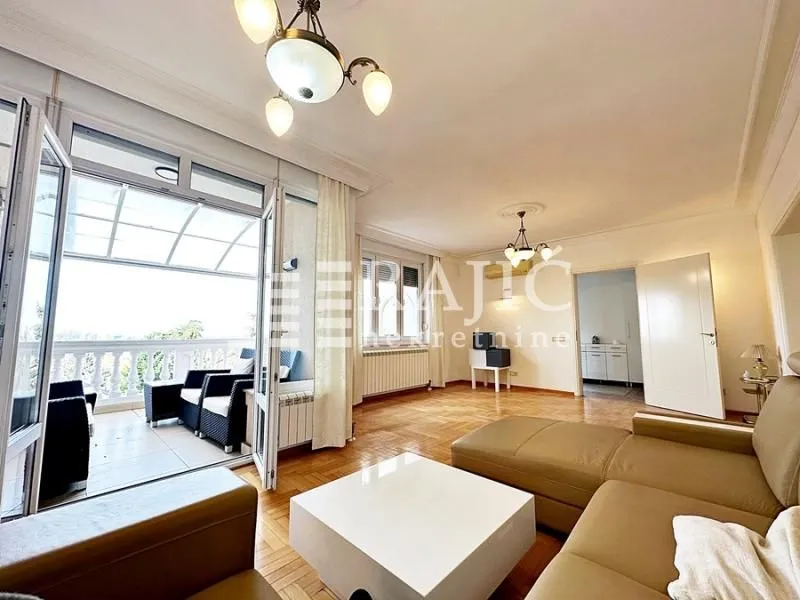 Spacious living room with furniture and terrace access.
