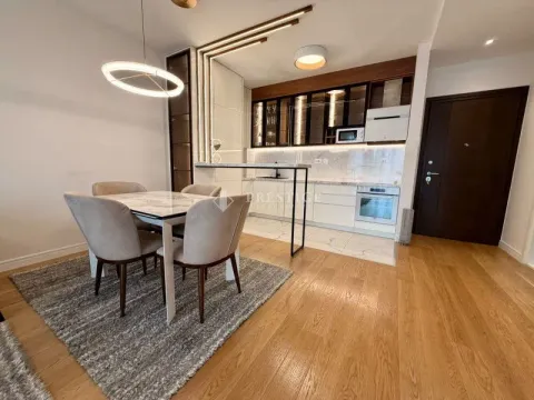 Modern kitchen with dining area and built-in appliances. - image 4