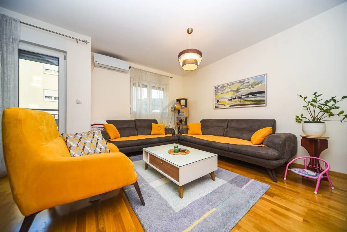 Living room furnished with a sofa set, armchair, and coffee table.
