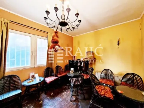 Living room furnished with wicker furniture and a chandelier. - image 10