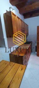 Wooden kitchen with cabinets and countertops. - image 17