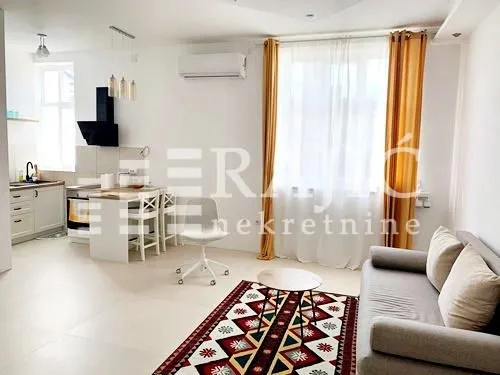Living room with dining area and open-plan kitchen.