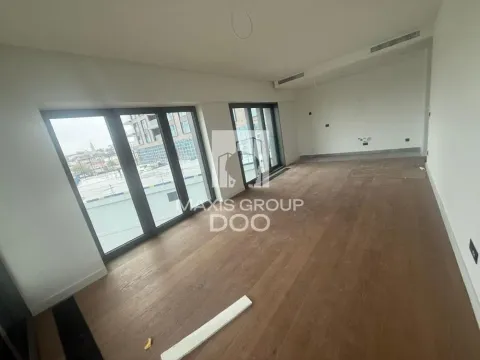 Empty room with wooden flooring and large glass windows. - image 3