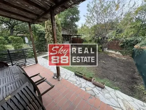 Covered terrace with a table and chairs overlooking the yard. - image 7