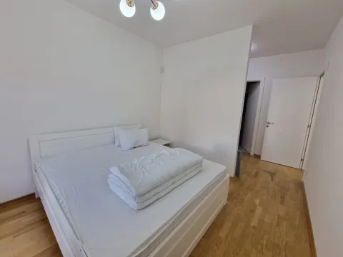 Bedroom with a large double bed and white bedding. - image 9