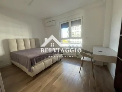 Furnished bedroom with a double bed, a desk, and a window. - image 11