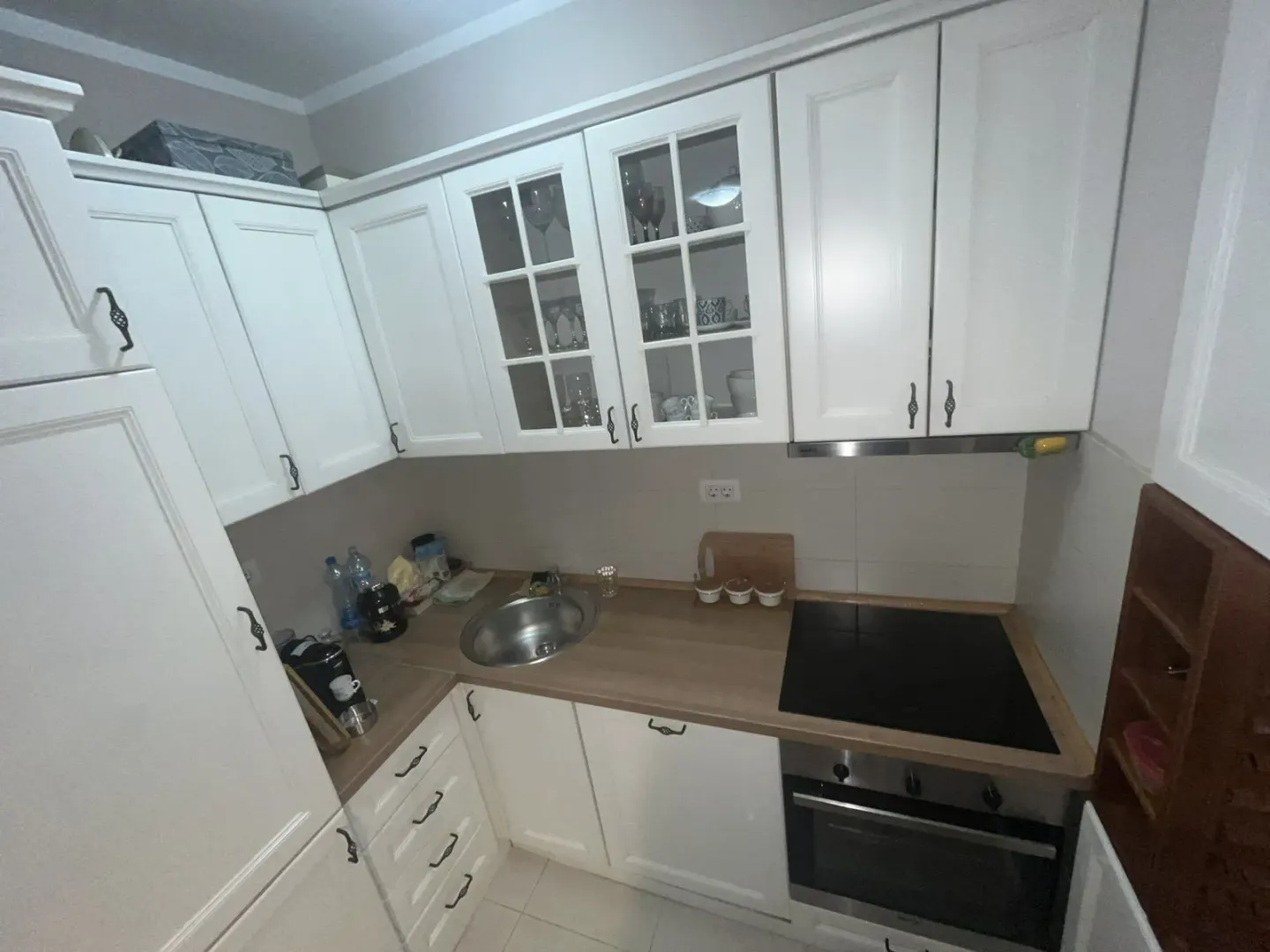 Bright kitchen with white cabinets and built-in appliances.