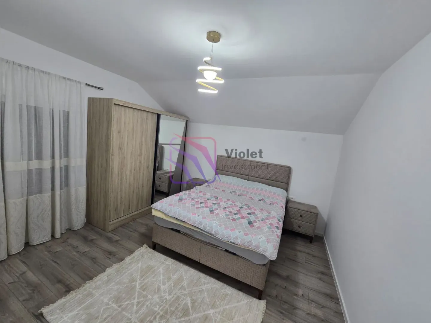 Furnished bedroom with a double bed, wardrobe, and nightstands.