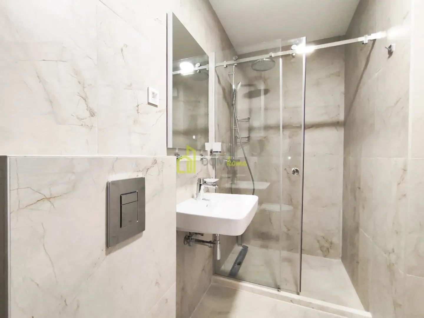 Modern bathroom with a walk-in shower and a washbasin.